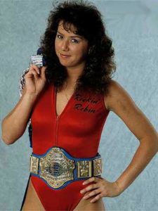 Wrestler Rockin' Robin wearing a championship belt