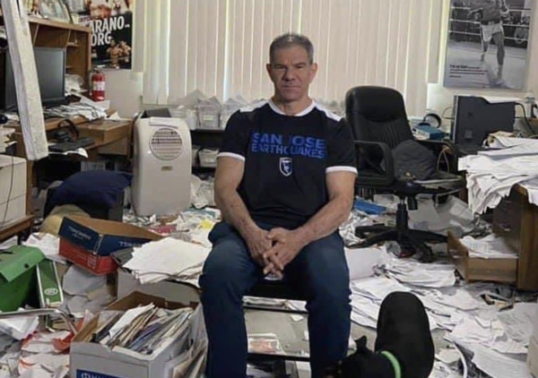 Dave Meltzer surrounded by paper in his office.