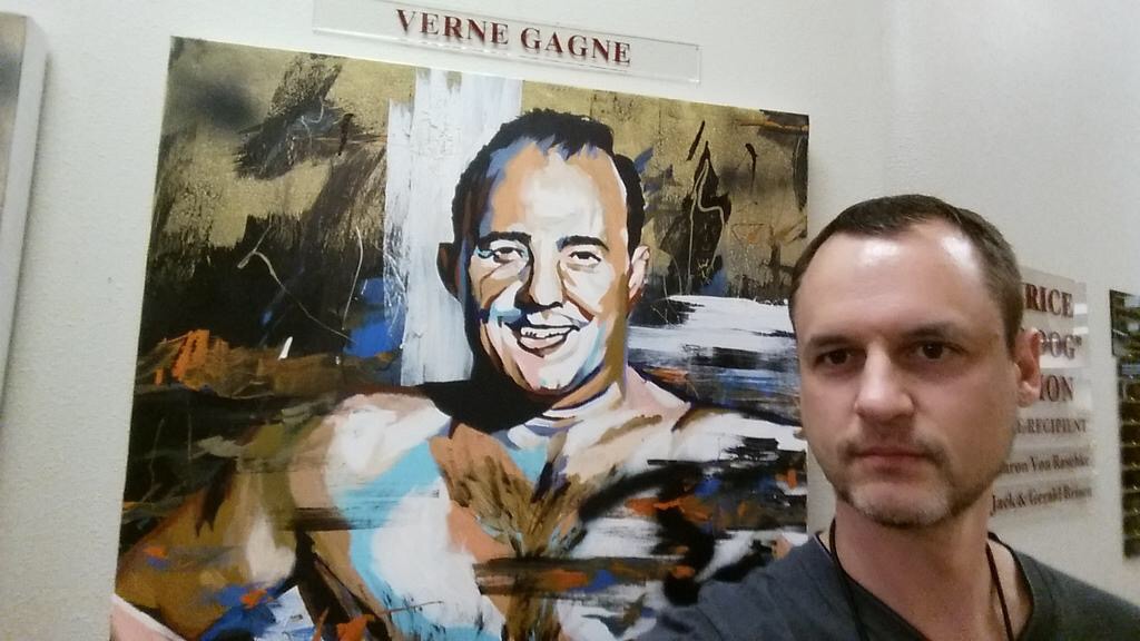 Wade Keller in front of painting of Verne Gagne
