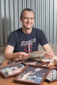 Wade Keller sitting in front of wrestling photos