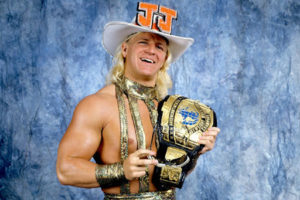Blond Jeff Jarrett holding championship belt