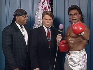 Johnny B. Badd wearing boxing gloves being interviewed by Tony Schiavone